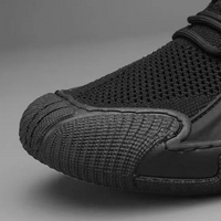 Schwarzer Sneaker aus Mesh und Gummi, seitliche Nahaufnahme, sportlich, modern, atmungsaktiv.