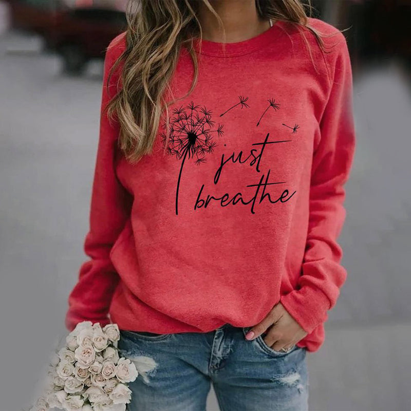 Rotes Damen-Sweatshirt mit Löwenzahn-Design und "Just Breathe"-Aufdruck, lässig, bequem.