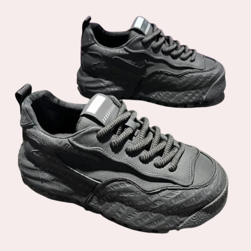 Graue Sneaker aus Leder mit geprägtem Logo, sportlich, modisch, für Herren und Damen.