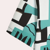 Abstraktes geometrisches Muster auf Stoff, türkis-schwarz-weiß, moderne Textildesigns.