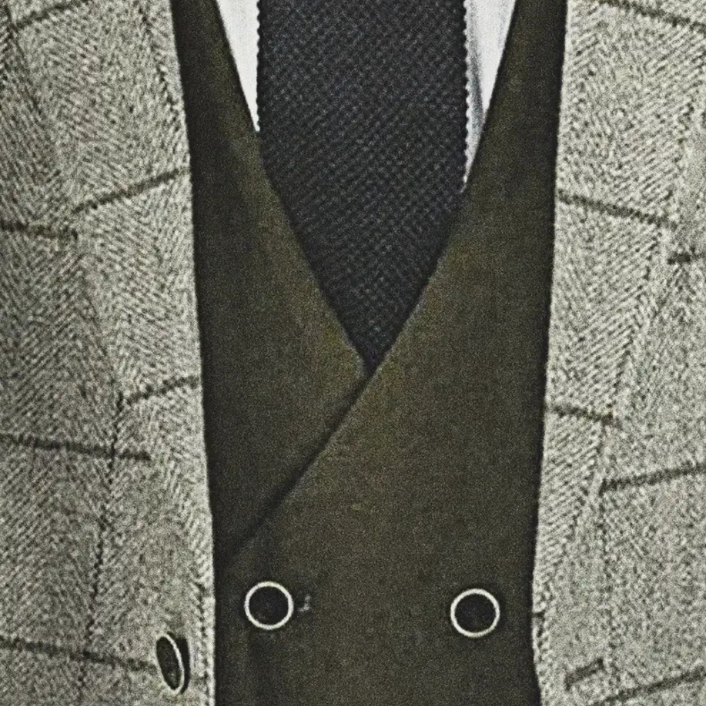 Grauer kariertes Sakko, schwarzer Krawatte, grüner Weste, Herrenmode, eleganter Anzug.